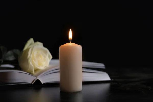 depositphotos_217592872-stock-photo-burning-candle-book-white-rose